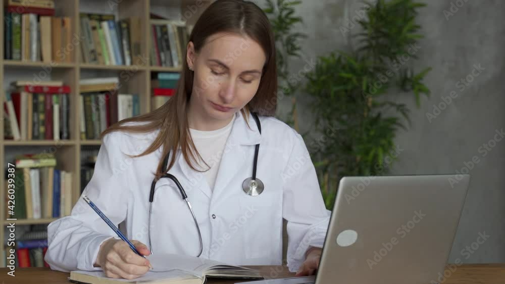 Woman doctor using on her laptop computer in medical office Woman doctor using on her laptop computer in medical office