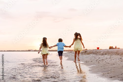 Little children having fun on sea beach