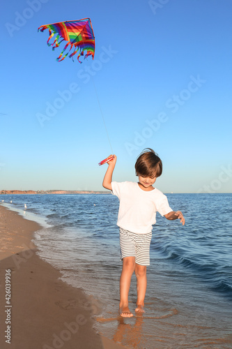 Cute little boy flying rain...