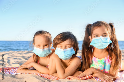 Children in medical masks o...