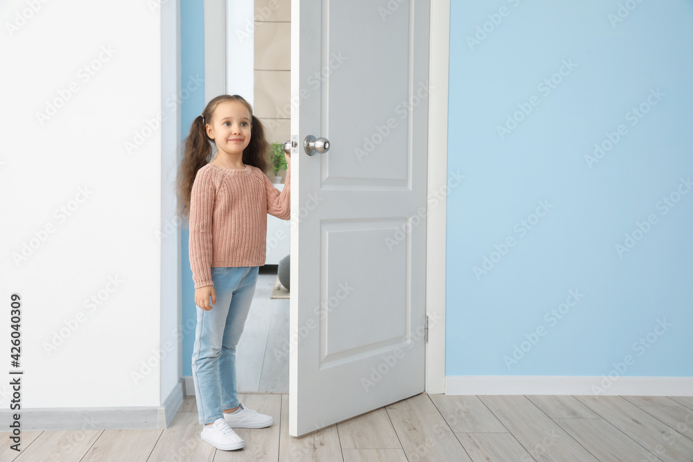 Cute little girl standing in doorway Cute little girl standing in doorway