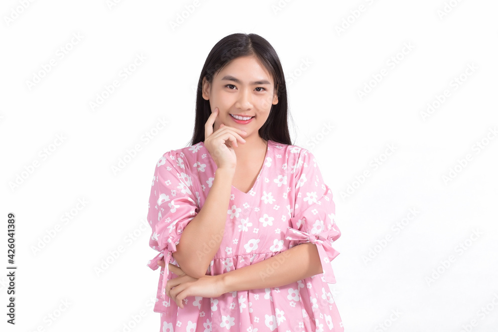 Asian beautiful lady in pink dress and black long hair. Her hands touch cheek, smile, show beautiful skin on white background. Asian beautiful lady in pink dress and black long hair. Her hands touch cheek, smile, show beautiful skin on white background.