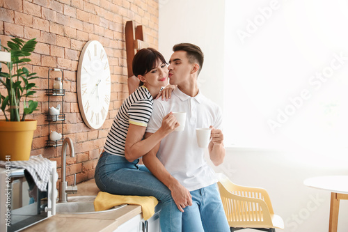 Happy young couple drinking...