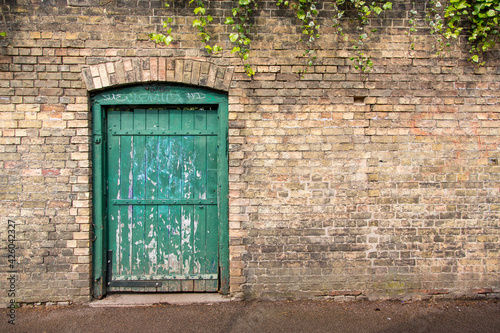 Green door in brick wall