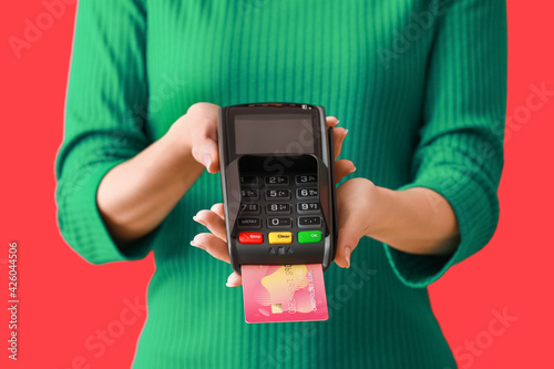 Woman holding POS terminal ...