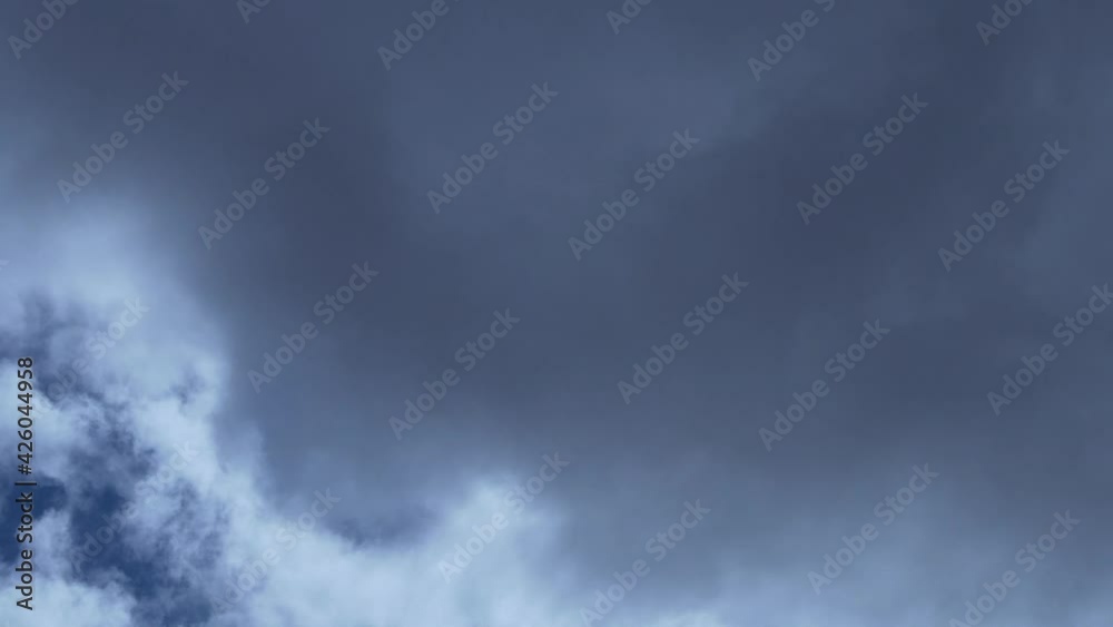 Beautiful Time Lapse of White and Gray Clouds of the Sun with Rays and Highlights in the Blue Sky. Cloudy Weather on A Sunny Summer Day. Background of Sun Clouds and Sky. Fresh Air, Layer, Atmosphere. Beautiful Time Lapse of White and Gray Clouds of the Sun with Rays and Highlights in the Blue Sky. Cloudy Weather on A Sunny Summer Day. Background of Sun Clouds and Sky. Fresh Air, Layer, Atmosphere.