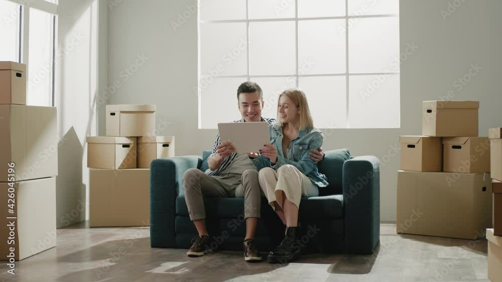 Inspired young family observes purchased apartment plan Inspired young family observes purchased apartment plan