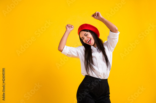 Photo of happy excited crazy cheerful smiling french woman raise fists in victory success isolated on yellow color background