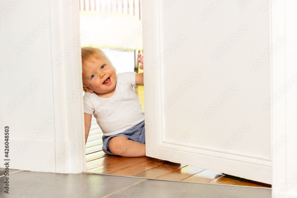 Laughing toddler small boy laugh sitting by door Laughing toddler small boy laugh sitting by door