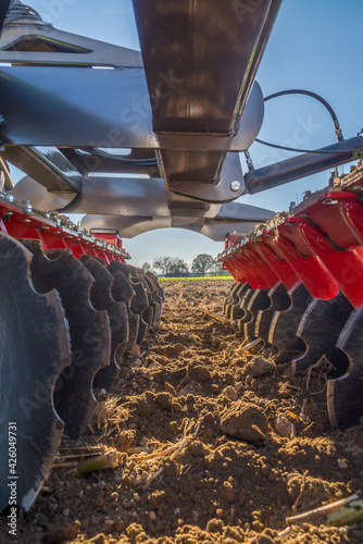 Soil dirty disc harrow machinery. Low angle view of heavy agriculture machinery
