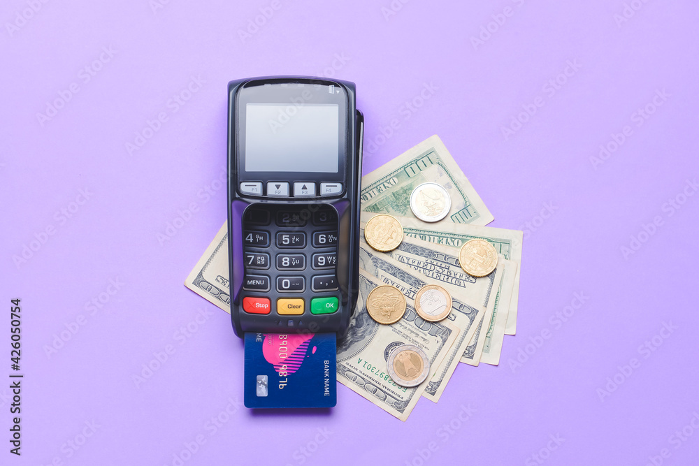 Payment terminal with credit card and money on color background Payment terminal with credit card and money on color background