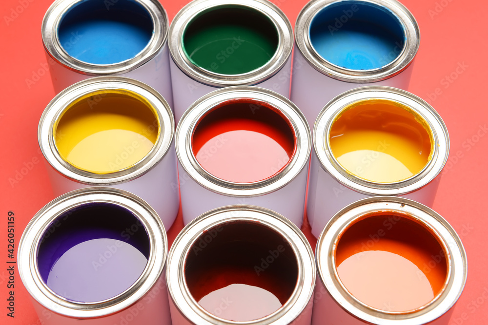 Cans of paints on color background, closeup Cans of paints on color background, closeup