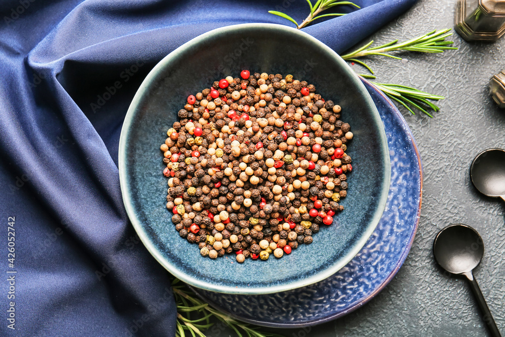Bowl with mixed peppercorns on dark background Bowl with mixed peppercorns on dark background