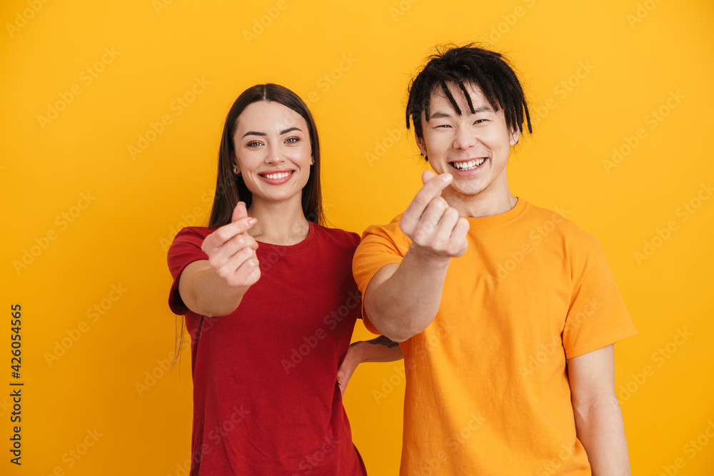 Young multiracial couple smiling and rubbing their fingers Young multiracial couple smiling and rubbing their fingers