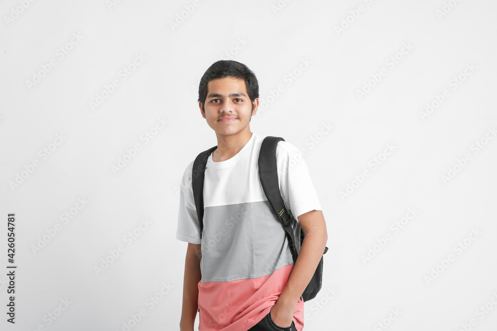 Young indian college student holding bag on white background. Young indian college student holding bag on white background.