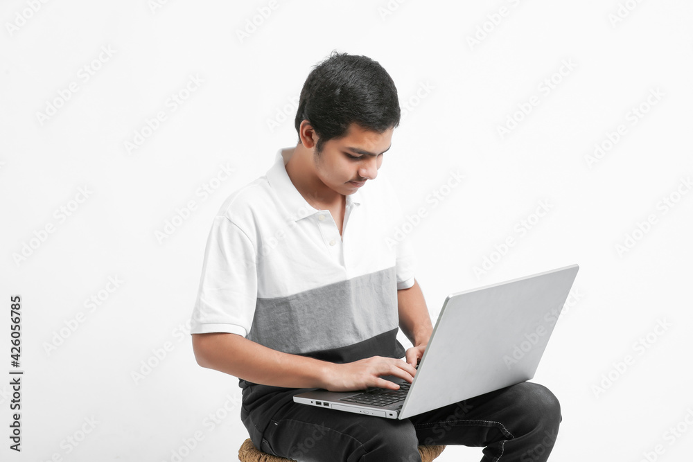 indian male college student using laptop indian male college student using laptop