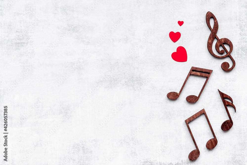 Love songs - musical wooden notes with heart, top view Love songs - musical wooden notes with heart, top view
