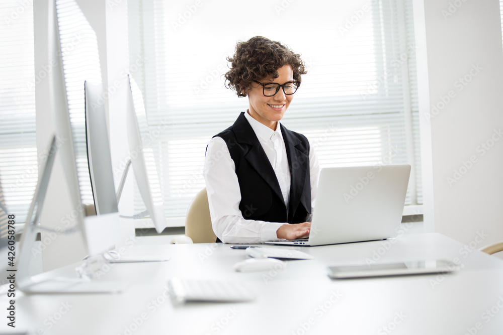 Portrait of a business woman at workplace in office Portrait of a business woman at workplace in office