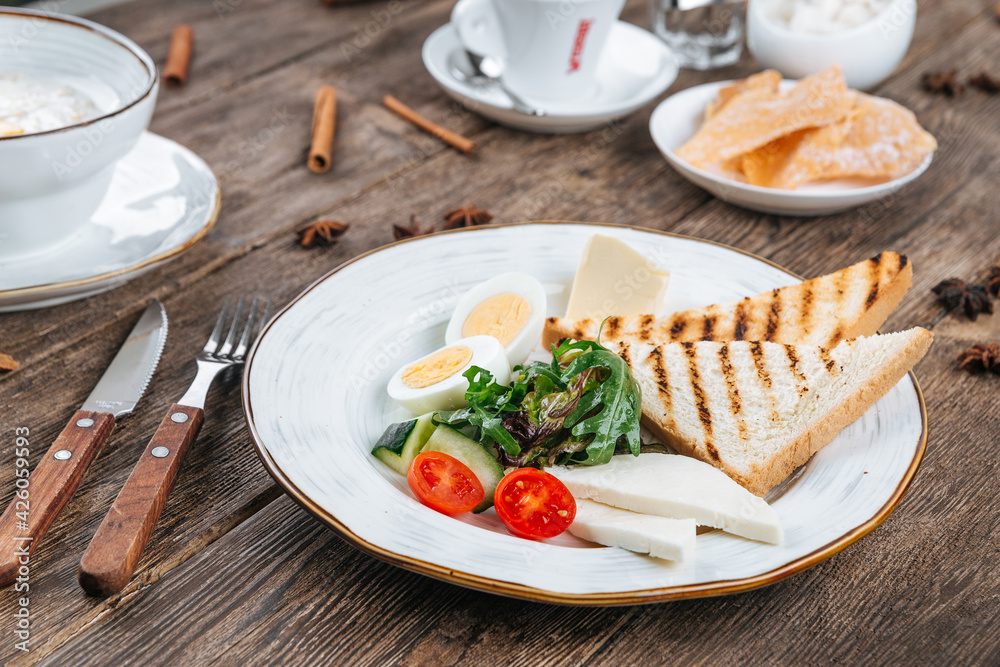 Table served with breakfast of fried eggs and toasts Table served with breakfast of fried eggs and toasts