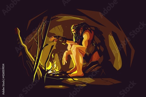 Wild caveman sitting near bonfire