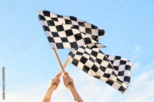 Woman with racing flags outdoors © Pixel-Shot