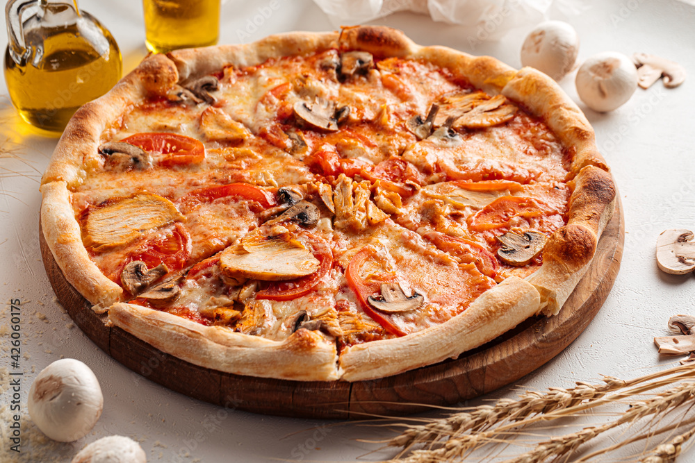 Fresh baked chicken and mushroom pizza on the white background Fresh baked chicken and mushroom pizza on the white background