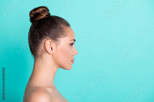 Profile side view portrait of attractive girl fresh pure skin aesthetic copy empty blank space isolated over bright teal turquoise color background