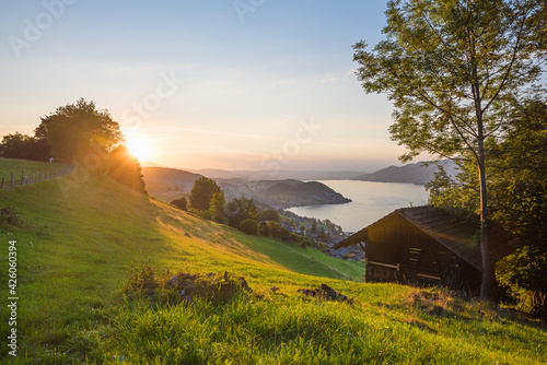 Sunset at lookout point buel, Krattigen, with wooden hut and view to lake Thunersee photo