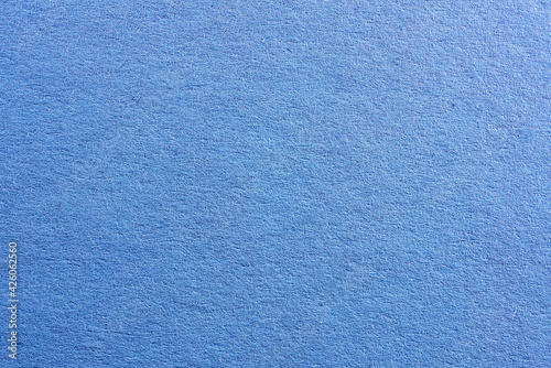 Blue colored paper with strong structure as a background, photographed in the studio