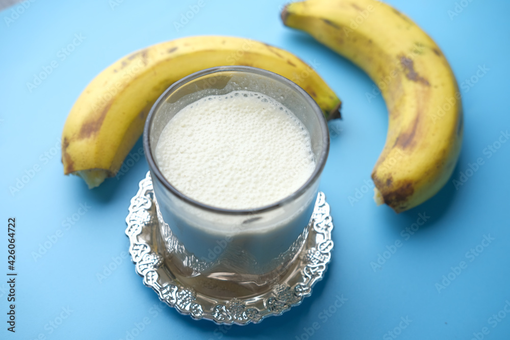  glass of milk and banana on table at morning 