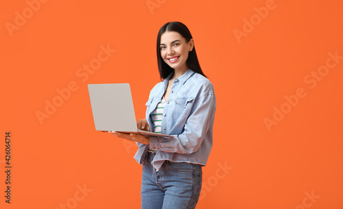 Young woman with laptop on ...