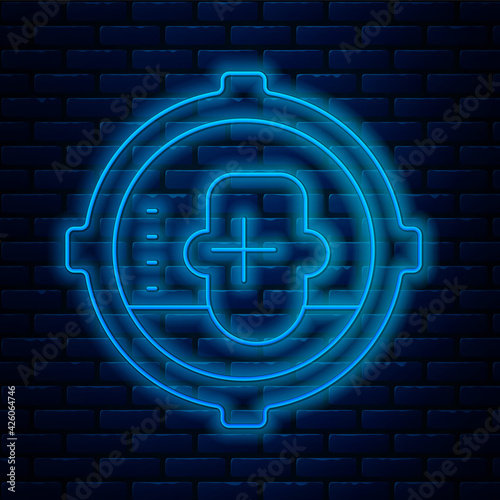 Glowing neon line Headshot icon isolated on brick wall background. Sniper and marksman is shooting on the head of man, lethal attack, assault and assassination. Vector
