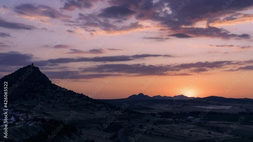 Timelapse of a sunset. At the top of the mountain a 15th century castle Timelapse of a sunset. At the top of the mountain a 15th century castle