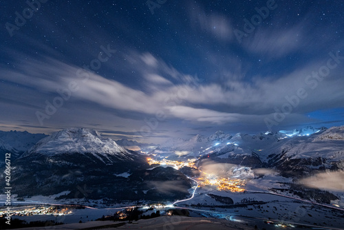 Starry winter sky over St. Moritz village and Upper Engadine covered with snow viewed from Muottas Muragl, Graubunden, Switzerland photo