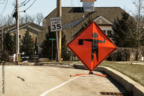 фотографія Bright orange and black flagger or flagman sign on the side of the road
