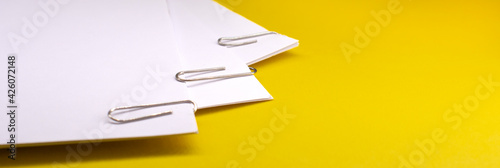 metal paper clips attached to a blank white paper