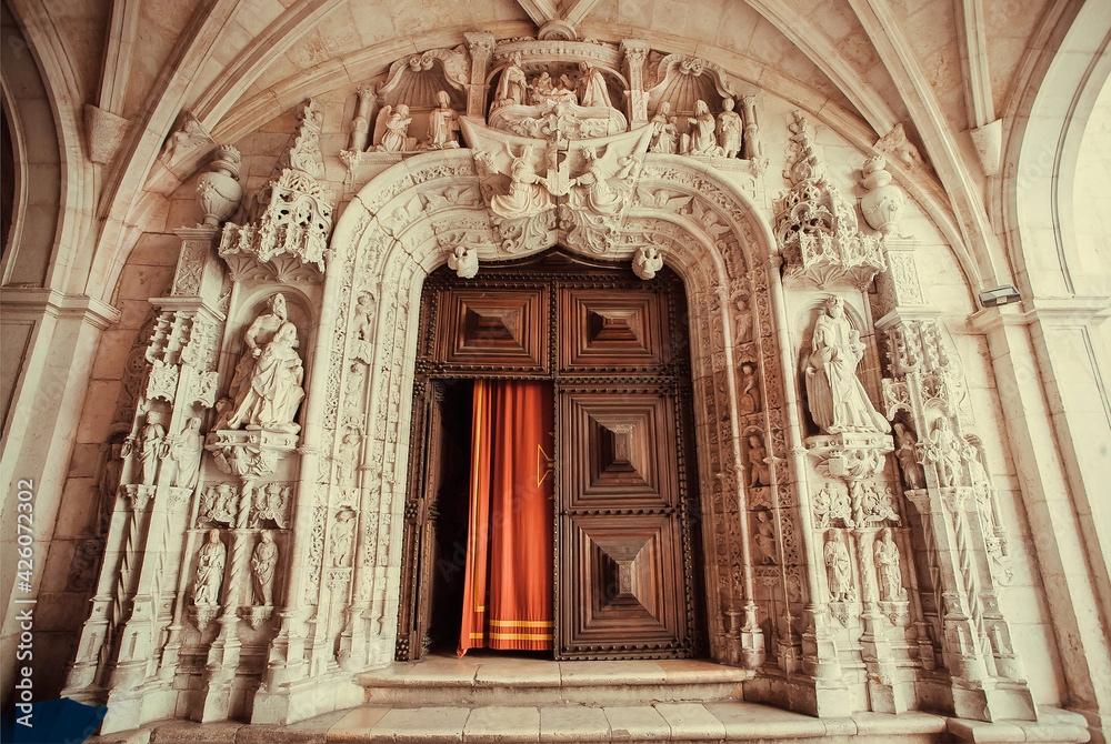 Gates of Santa Maria de Belem Church with carved entrance and decorations in Gothic style. Lisbon.