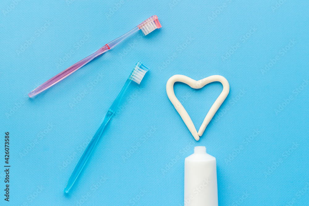 Heart shape of toothpaste with toothbrush, top view. Oral care and hygiene Heart shape of toothpaste with toothbrush, top view. Oral care and hygiene
