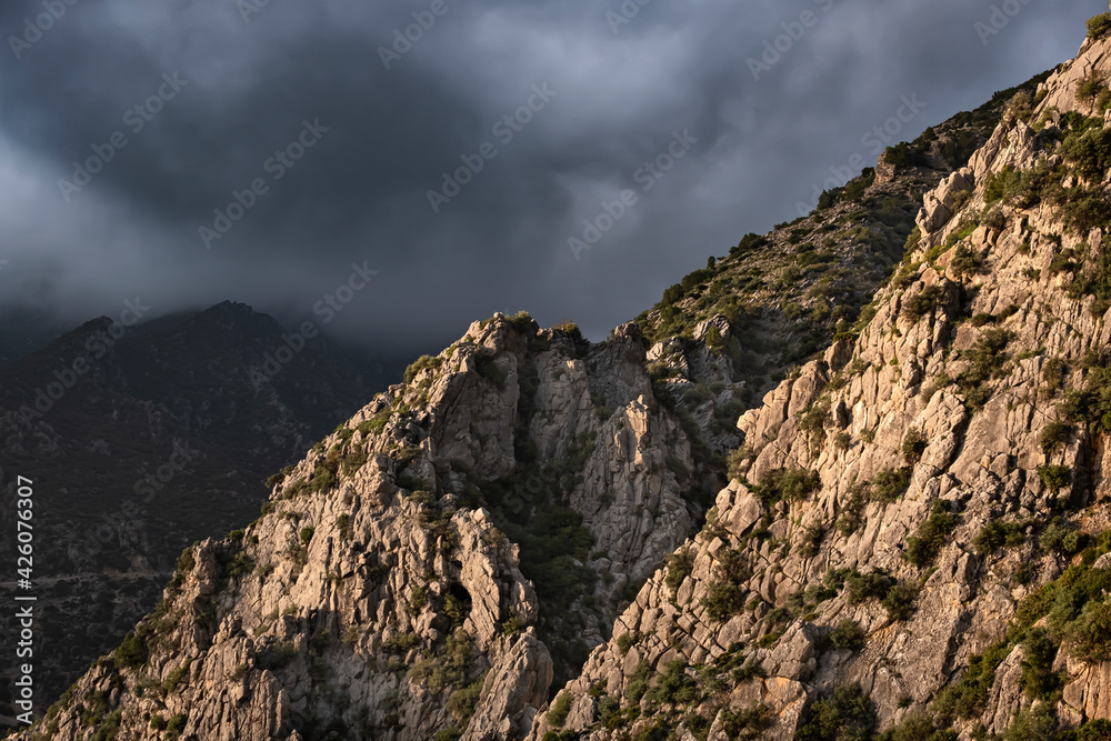 Sunset light on a rocky mountain and dark clouds in the sky, Chefchaouen, Morocco, North Africa Sunset light on a rocky mountain and dark clouds in the sky, Chefchaouen, Morocco, North Africa