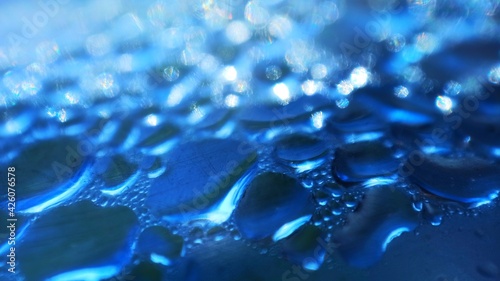 vertical aspect ratio, blue bokeh light effect, water blurred highlights, abstract image background color