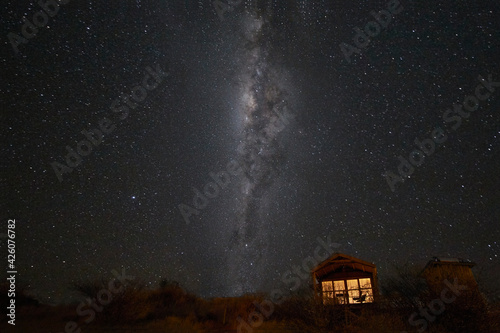 South hemisphere Milky Way and a small illuminated hut, Namibia