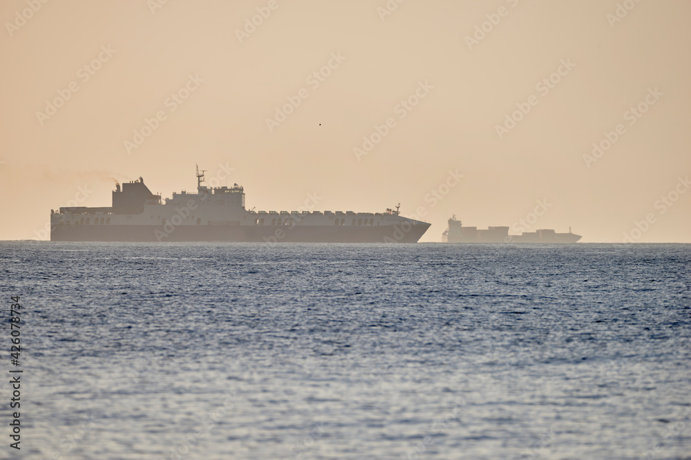 ferries and ships on the horizon on the open sea