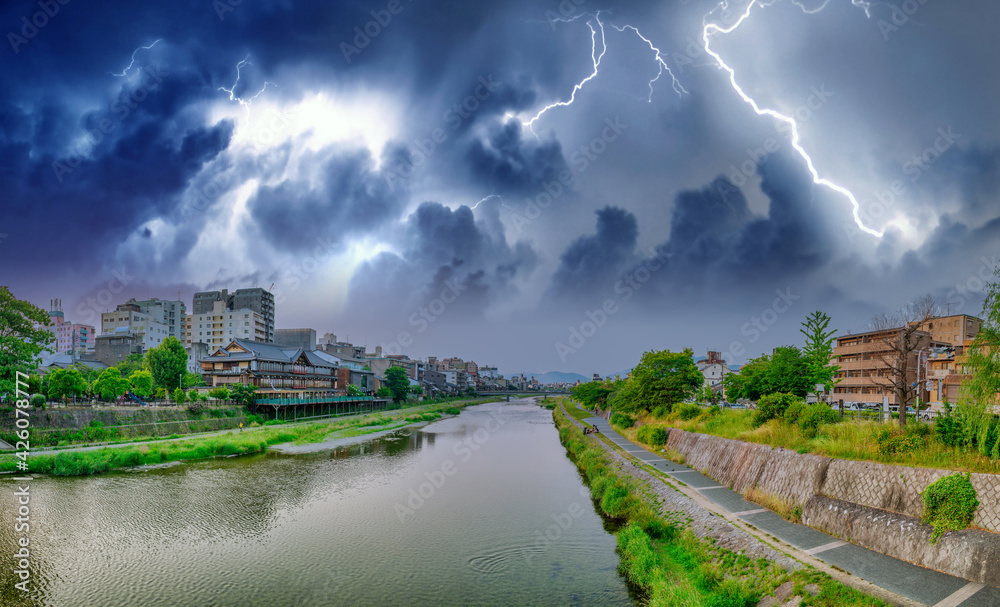 Kamo river and Kyoto skyline during a storm, Japan