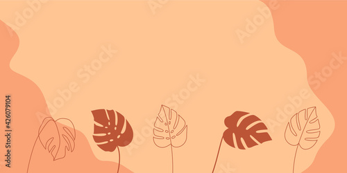 Monstera deliciosa leaves on a light orange background with copy space