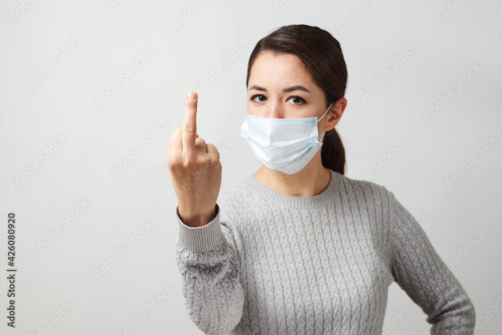 Young woman wearing medical mask, white background. Young woman wearing medical mask, white background.