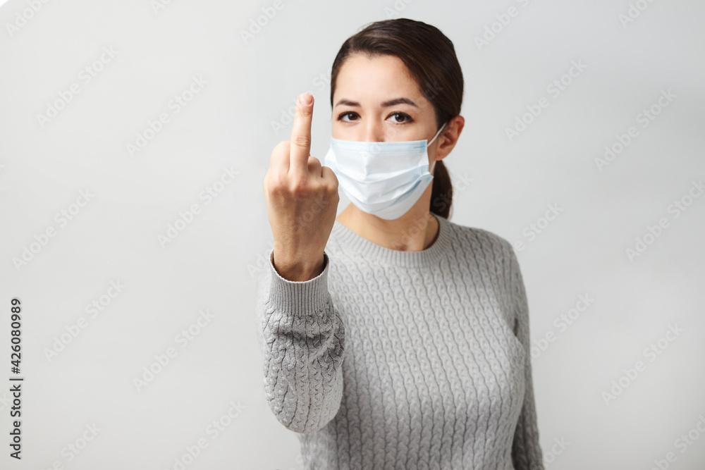 Young woman wearing medical mask, white background. Young woman wearing medical mask, white background.
