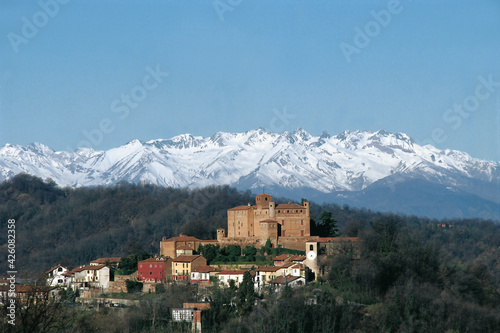 the ancient village of Bardassano with tower and castle on the hills near Turin and the Alps in Piedmont