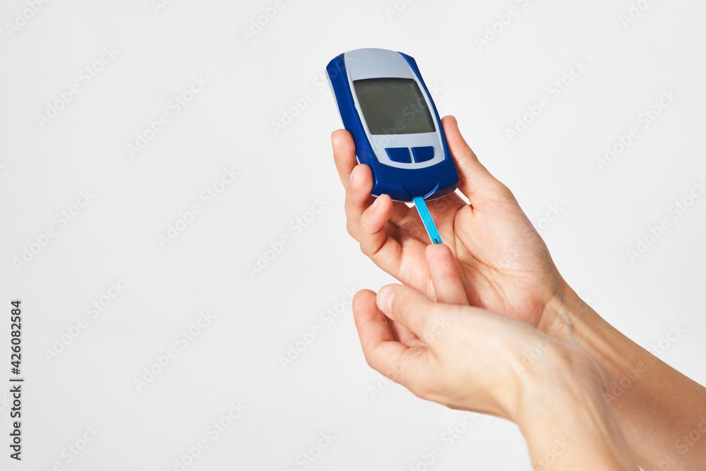 Woman with blood glucose meter, close-up Woman with blood glucose meter, close-up