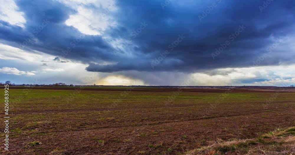 Timelapse. White clouds move quickly across the blue sky over fields Timelapse. White clouds move quickly across the blue sky over fields