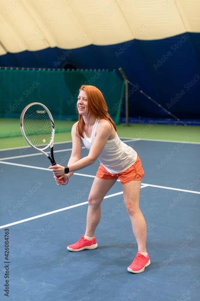 Female tennis player concentrated on game. Woman waits for the pitch to hit the ball back